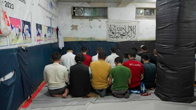 Afghanische Athleten beten in einem Judo-Klub in Kabul während des Trainings vor der Taliban-Flagge.